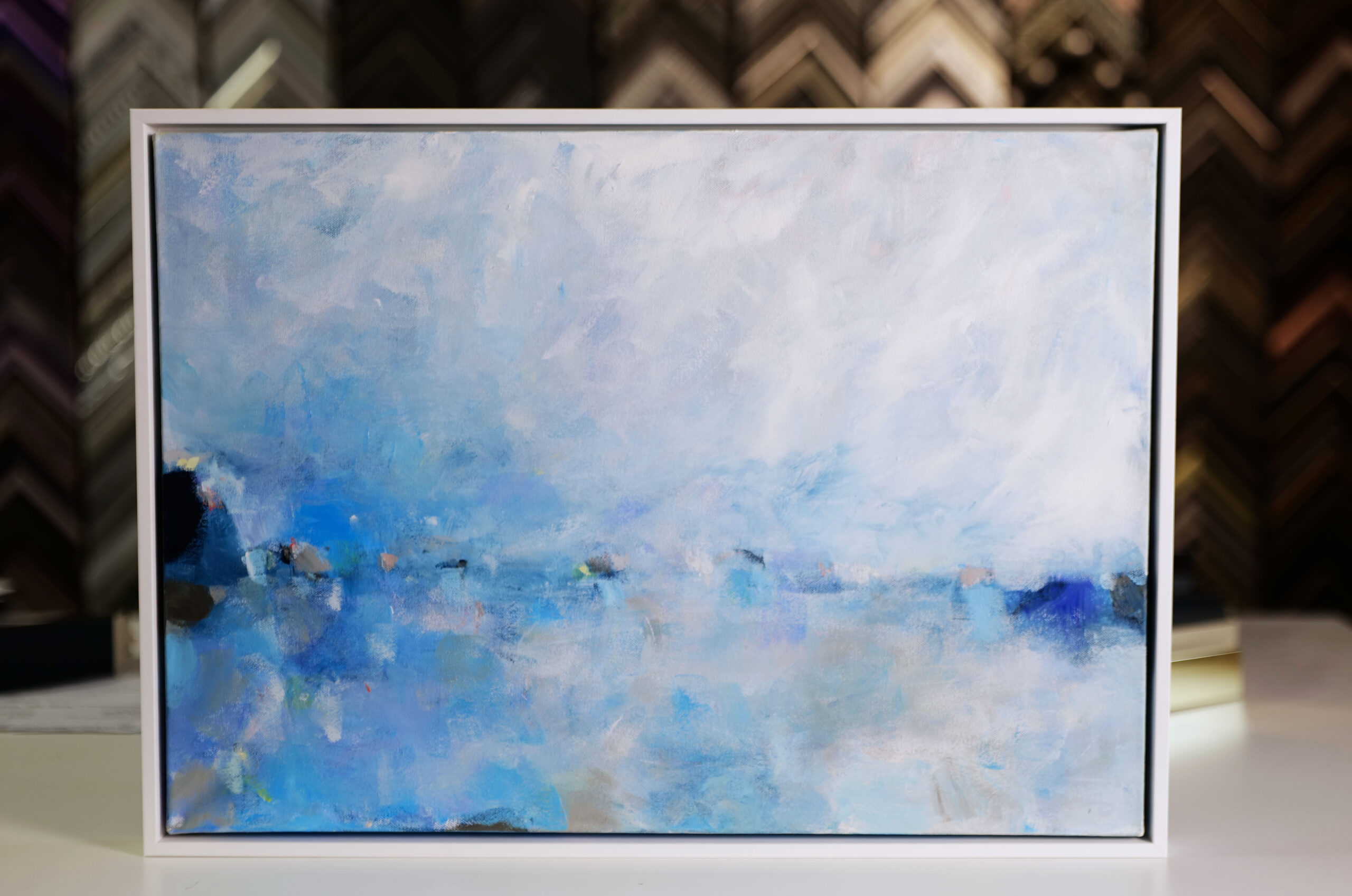 Blue abstract flowing canvas stretched in white floater frame